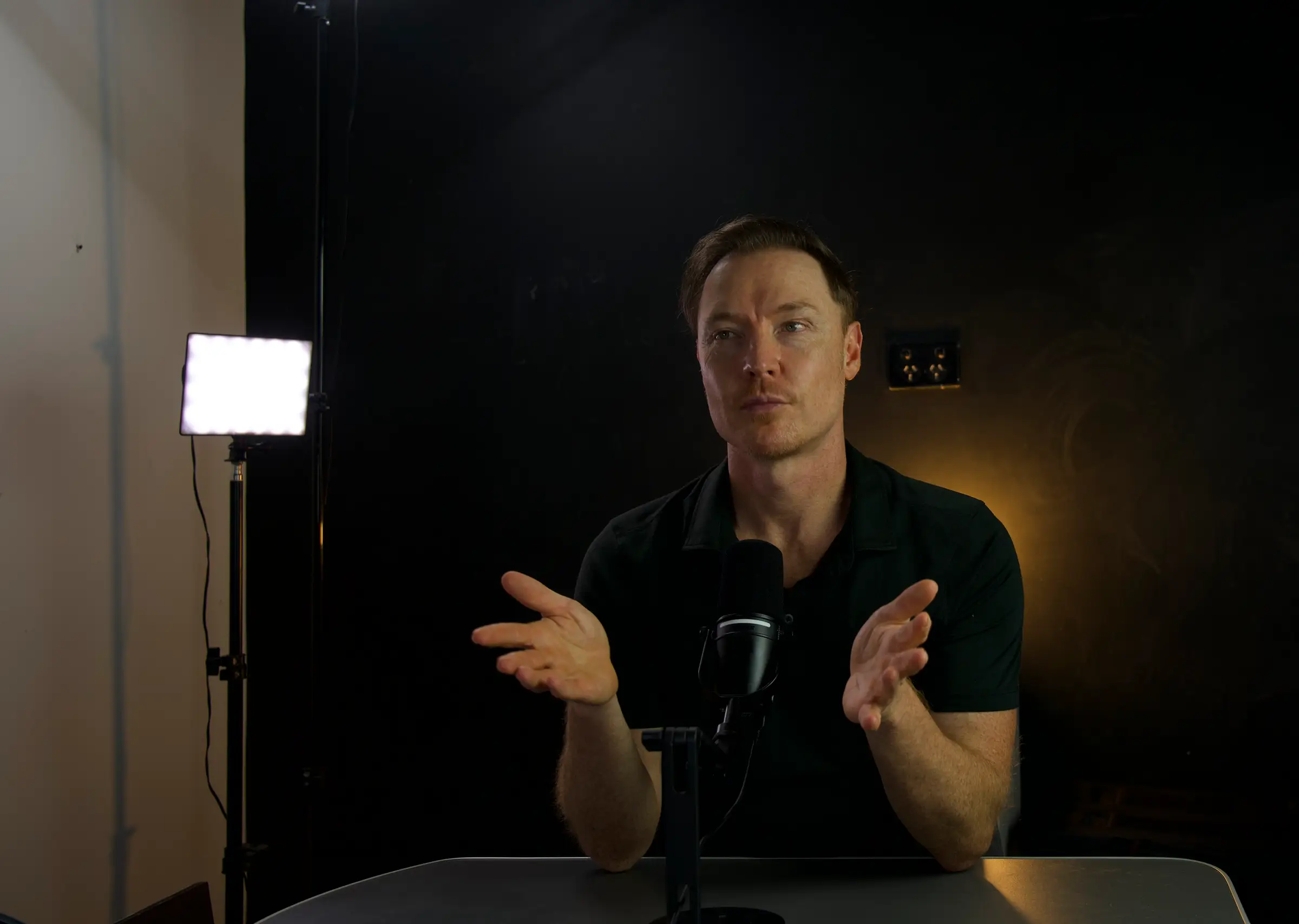 Brad Hook in the studio, mid-conversation at the microphone